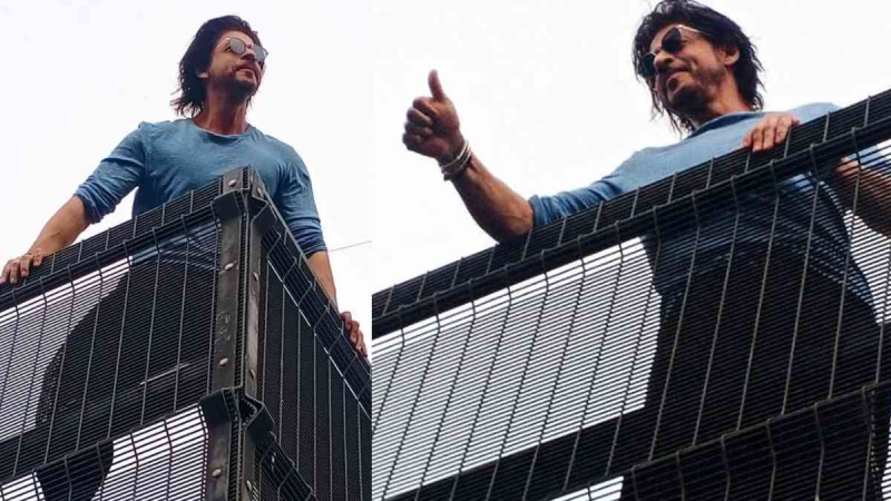 In an outdoor greeting, Shah Rukh Khan blows kisses to fans and strikes his signature pose